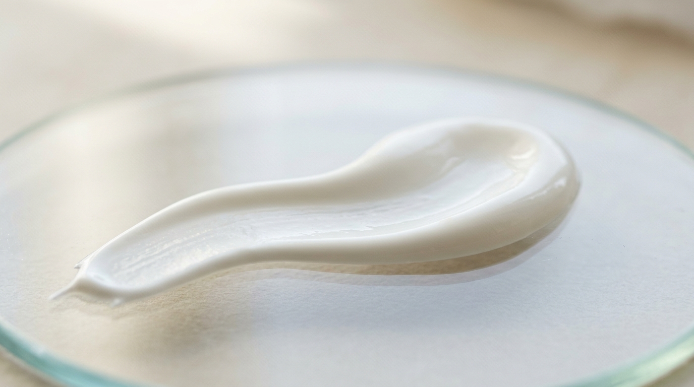 White sunscreen lotion spread on glass for a filter and texture explainer