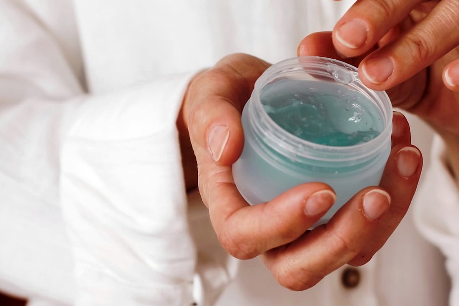 Hands holding skincare product for Chemical sunscreen filters in the UK and US.