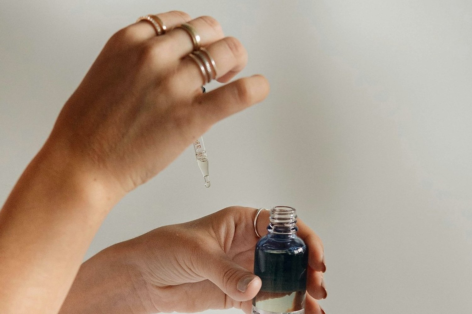 Hands holding skincare product for Combination skin SPF.