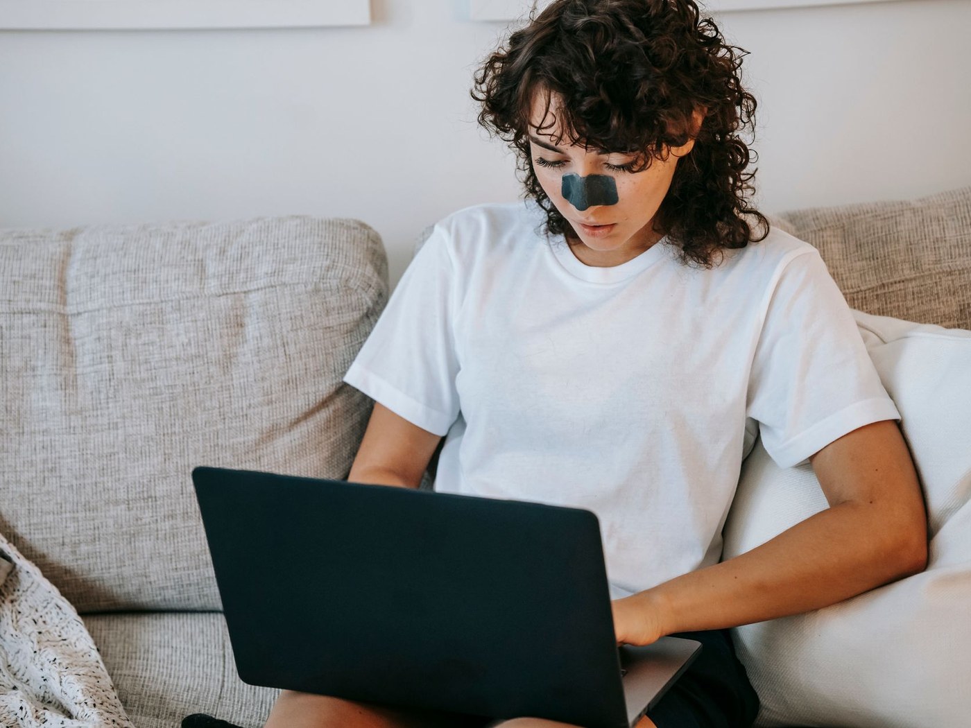 Shopper checking an online skincare seller on a laptop before ordering sunscreen