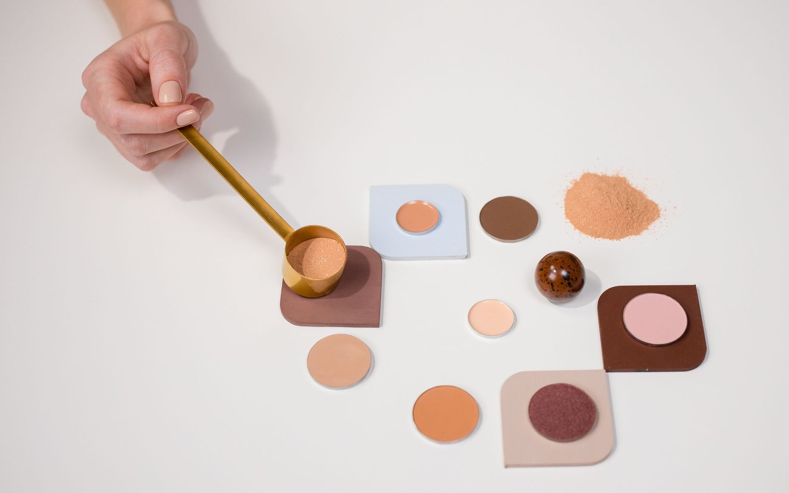 Powder sunscreen brush, compact makeup and liquid sunscreen arranged for a touch-up routine