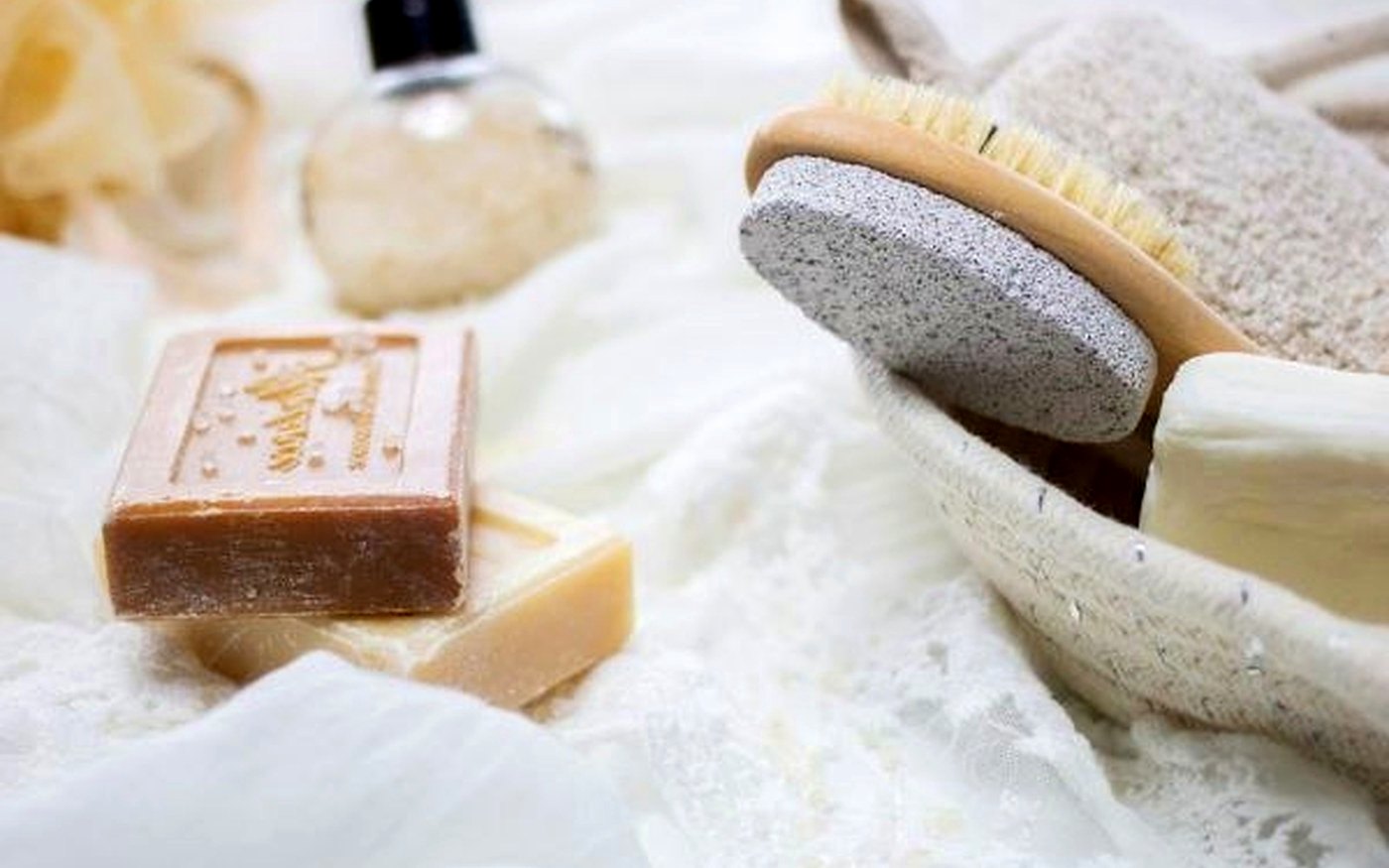 Travel-size SPF and skincare products on a towel