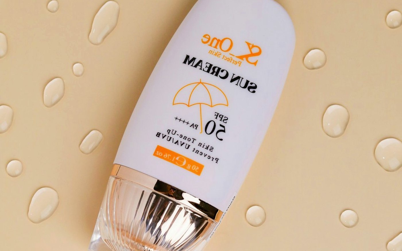 SPF 50 bottle on a water-drop surface for oily skin sunscreen guidance
