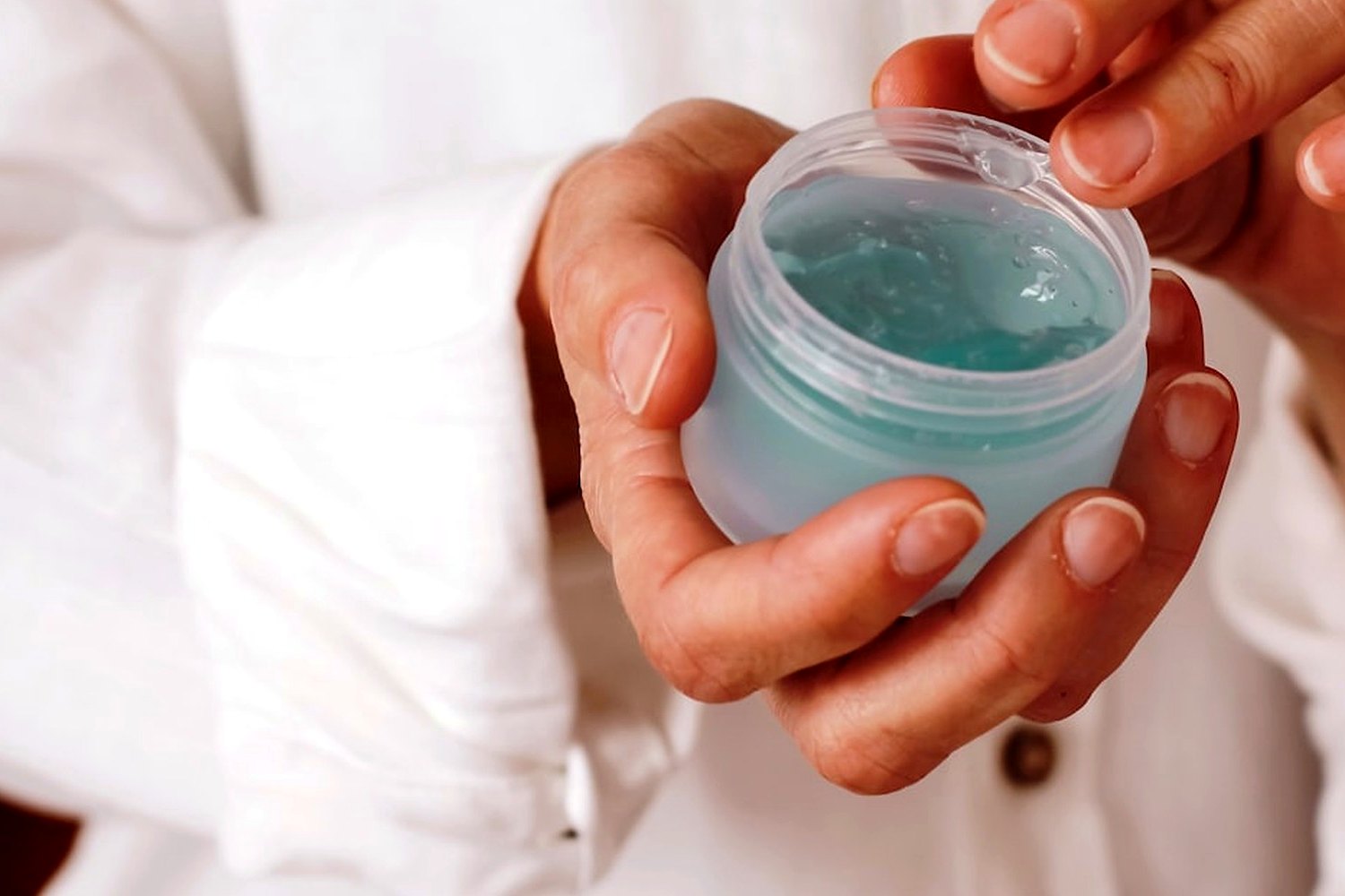 Hands holding skincare product for Sunscreen for oily skin without a heavy shine.